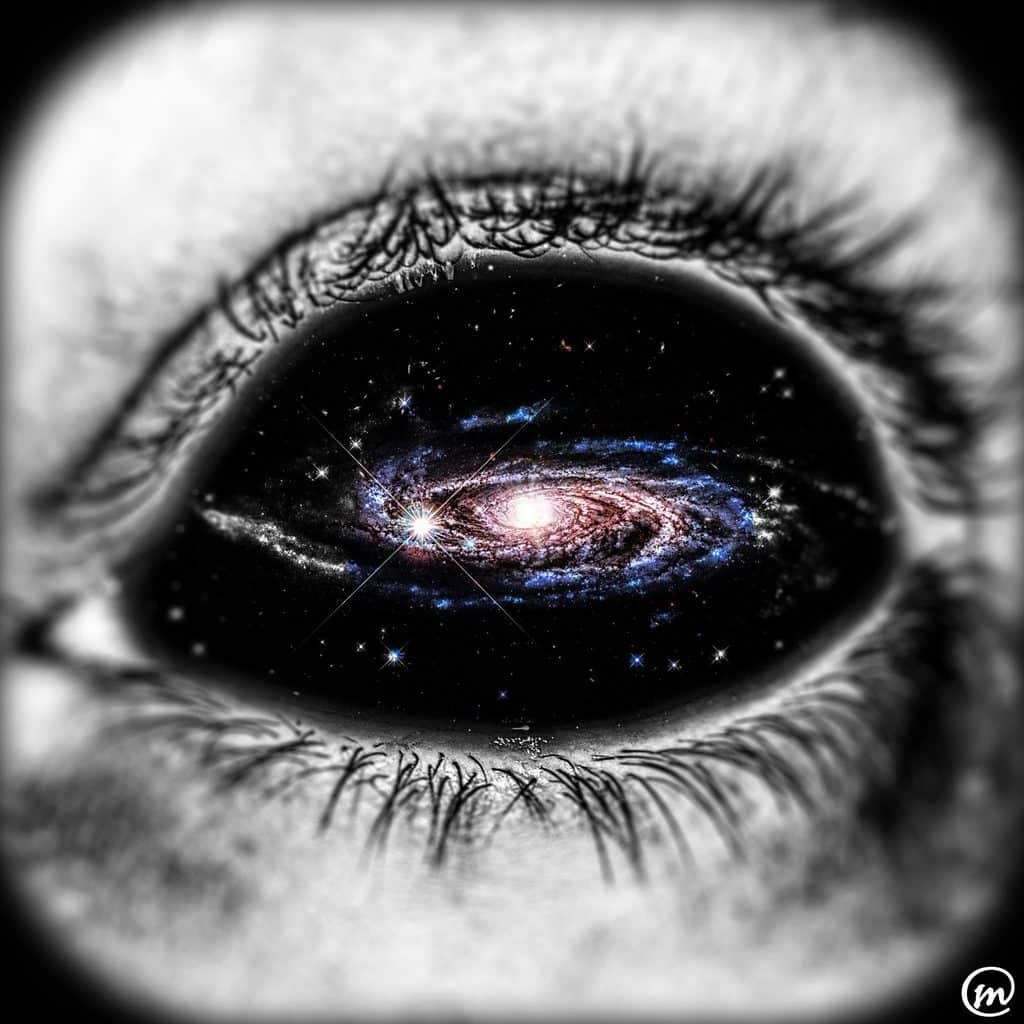 Black and white close-up of a human eye containing a vibrant spiral galaxy in place of a pupil.